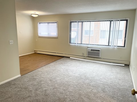 A room with a window and a door.